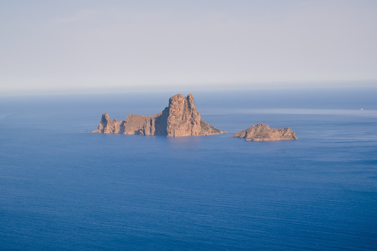 Es Vedrà rock rising from the sea on a boat trip from Ibiza